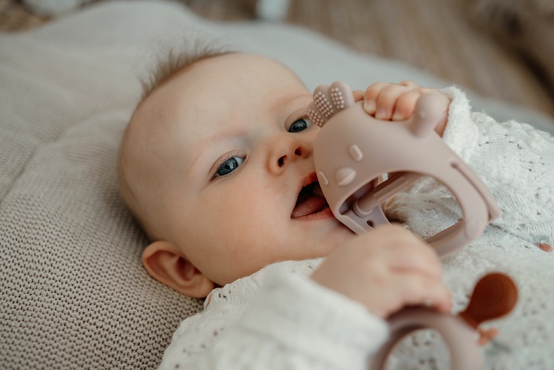 Baby with a teething ring