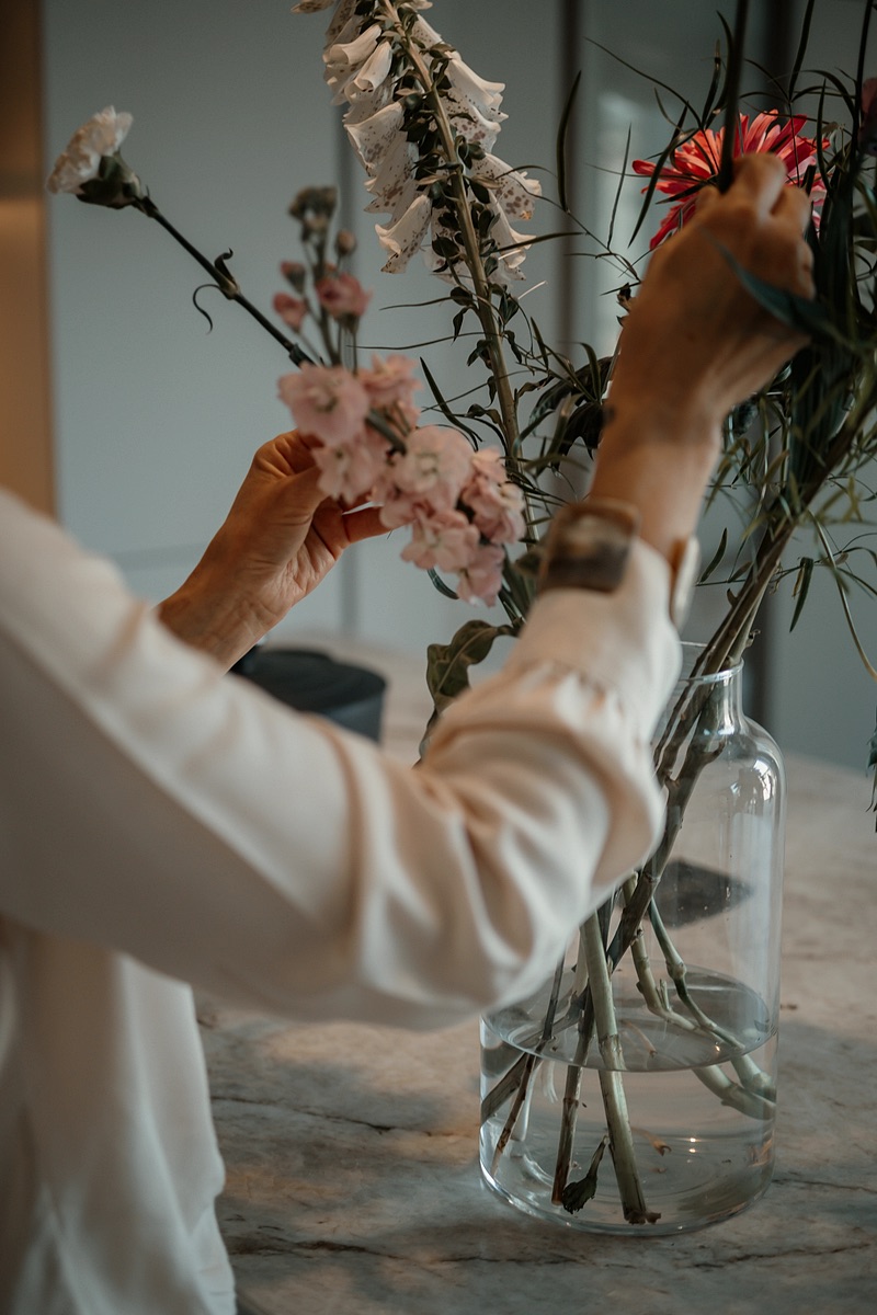 Fresh flowers being arranged in a vase