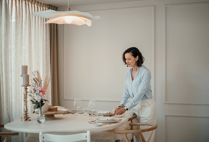 Family assistant laying the table for dinner