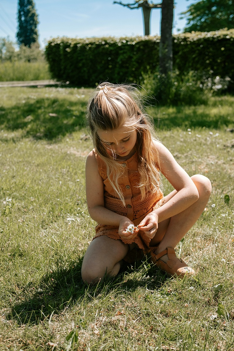 Girl picking flowers along the path
