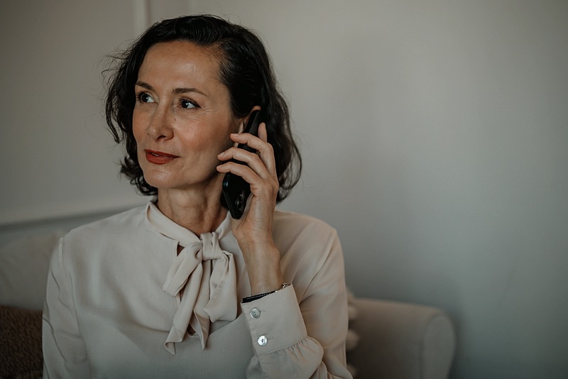 Personal assistant making a phone call at home